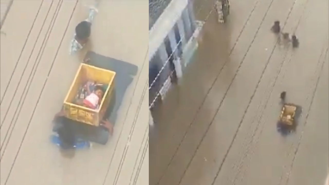 andhra pradesh rains: 2 men carry baby in crate through neck-deep flood waters in vijayawada- video