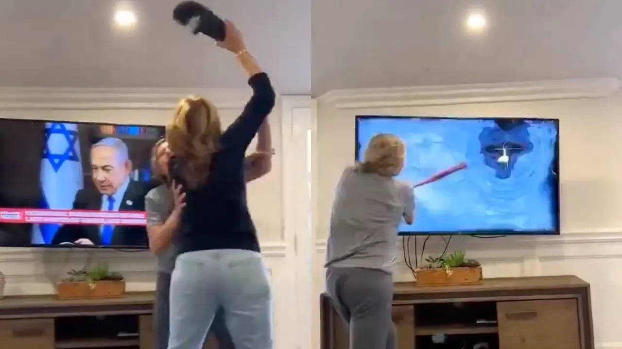 woman stopped from swatting netanyahu on tv before screen smashed with a bat: 'that's how you do it'