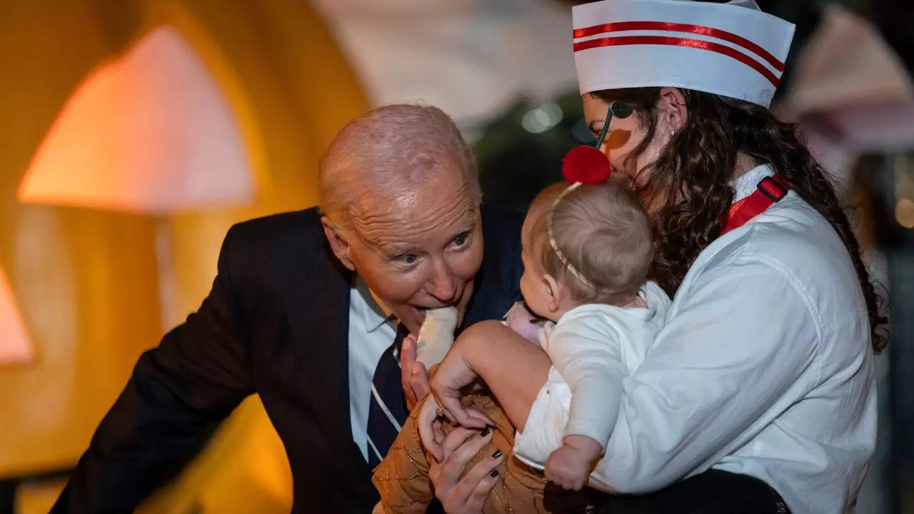 joe biden photographed biting babies at white house halloween celebrations