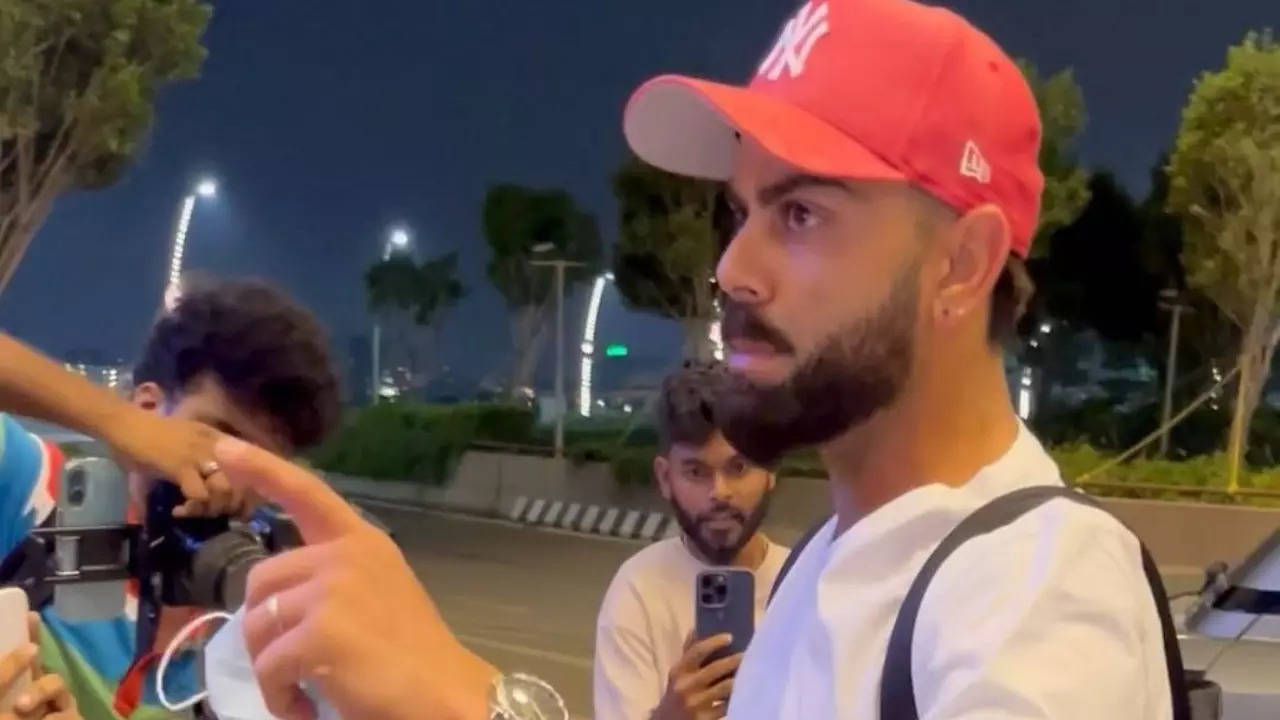 visibly annoyed virat kohli tells paps 'us taraf camera nahi karna' as he protects anushka sharma, kids at airport. watch